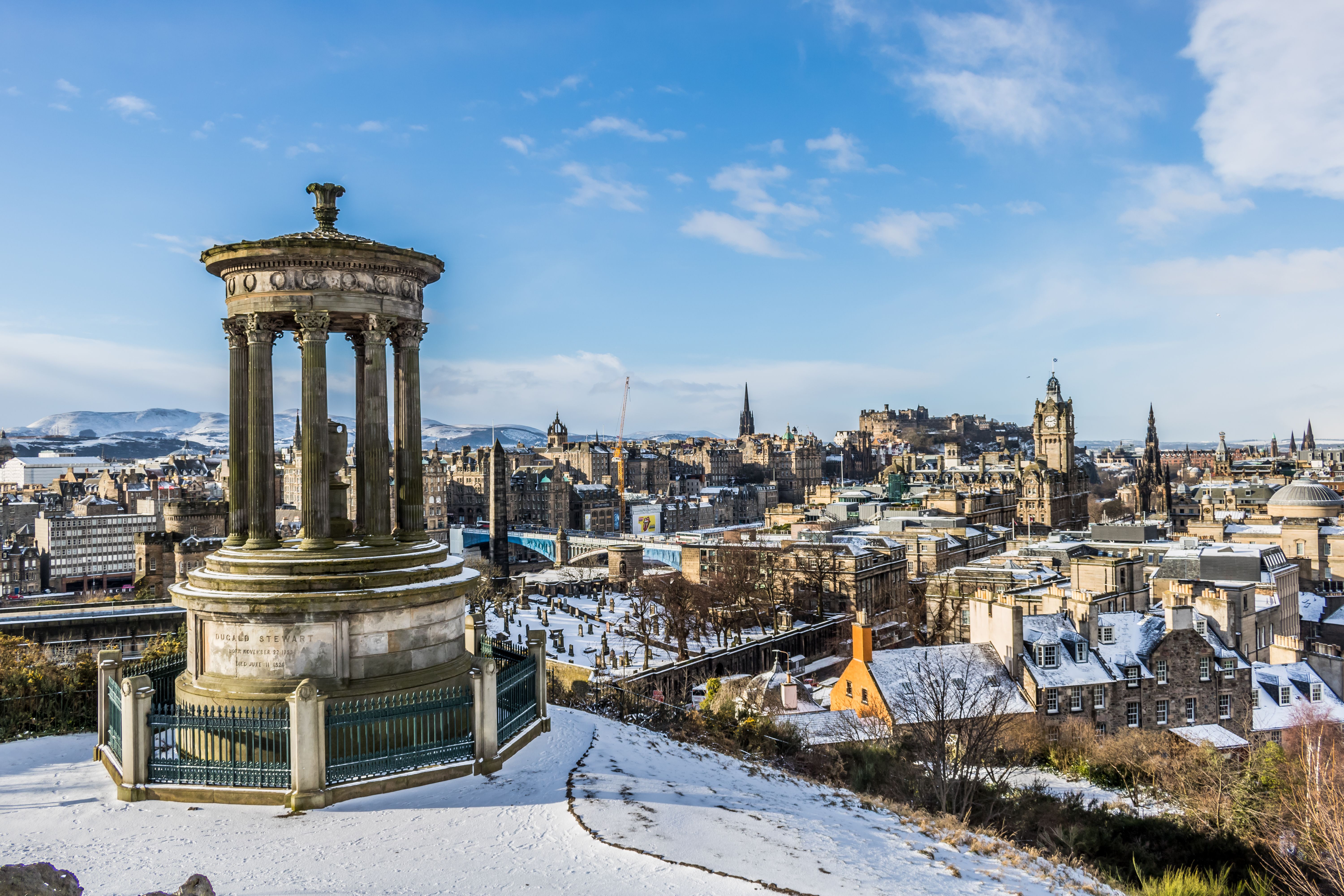 Aerial view of Edinburgh city with princess street and Edinburgh castle (old town) covered in snow