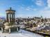 Aerial view of Edinburgh city with princess street and Edinburgh castle (old town) covered in snow