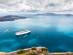 Beautiful landscape with sea view showing a cruise liner on the Aegean sea near the island of Santorini in Greece