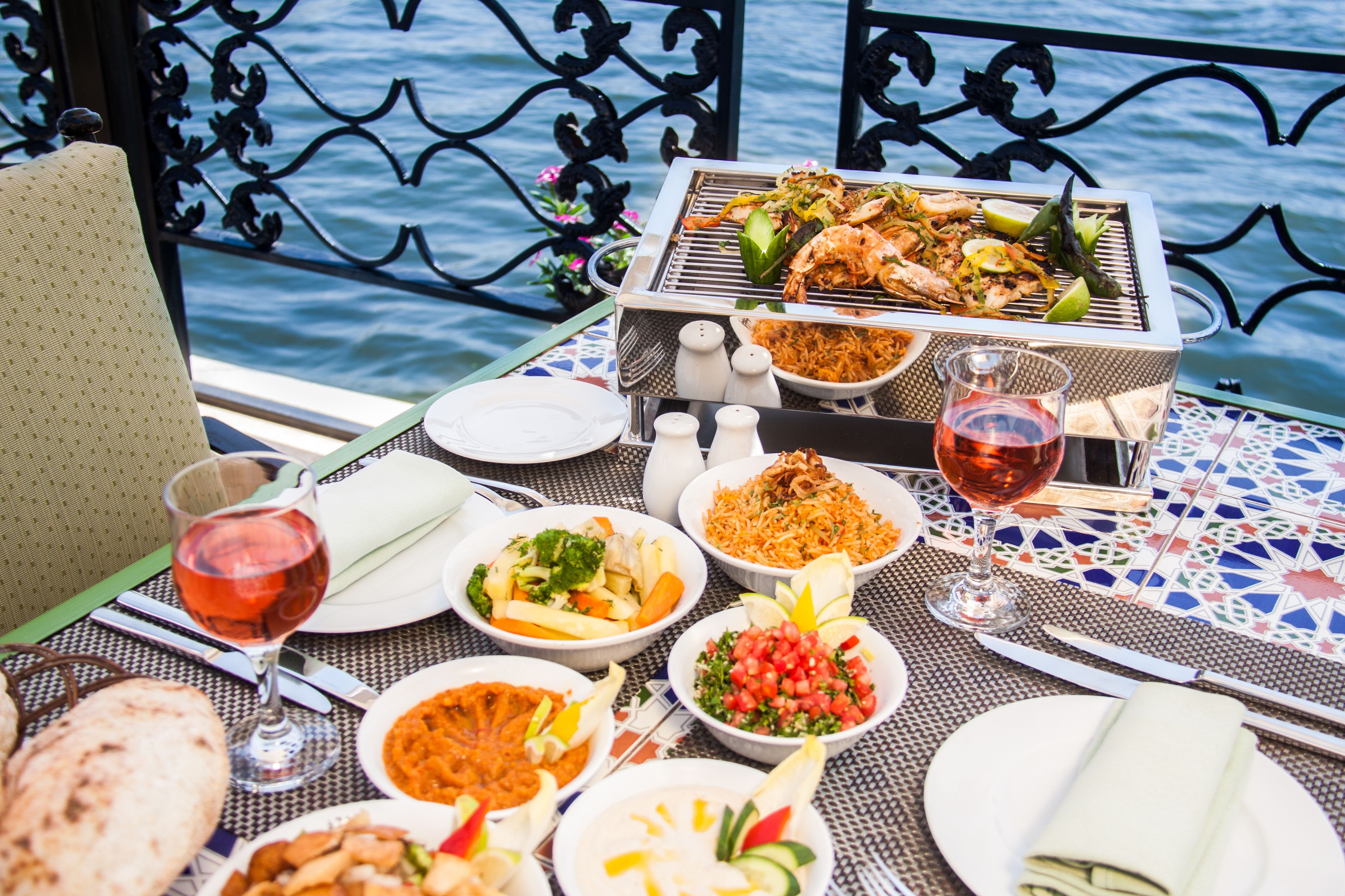 Traditional Egyptian food dishes laid out on a table by the river in Cairo, Egypt