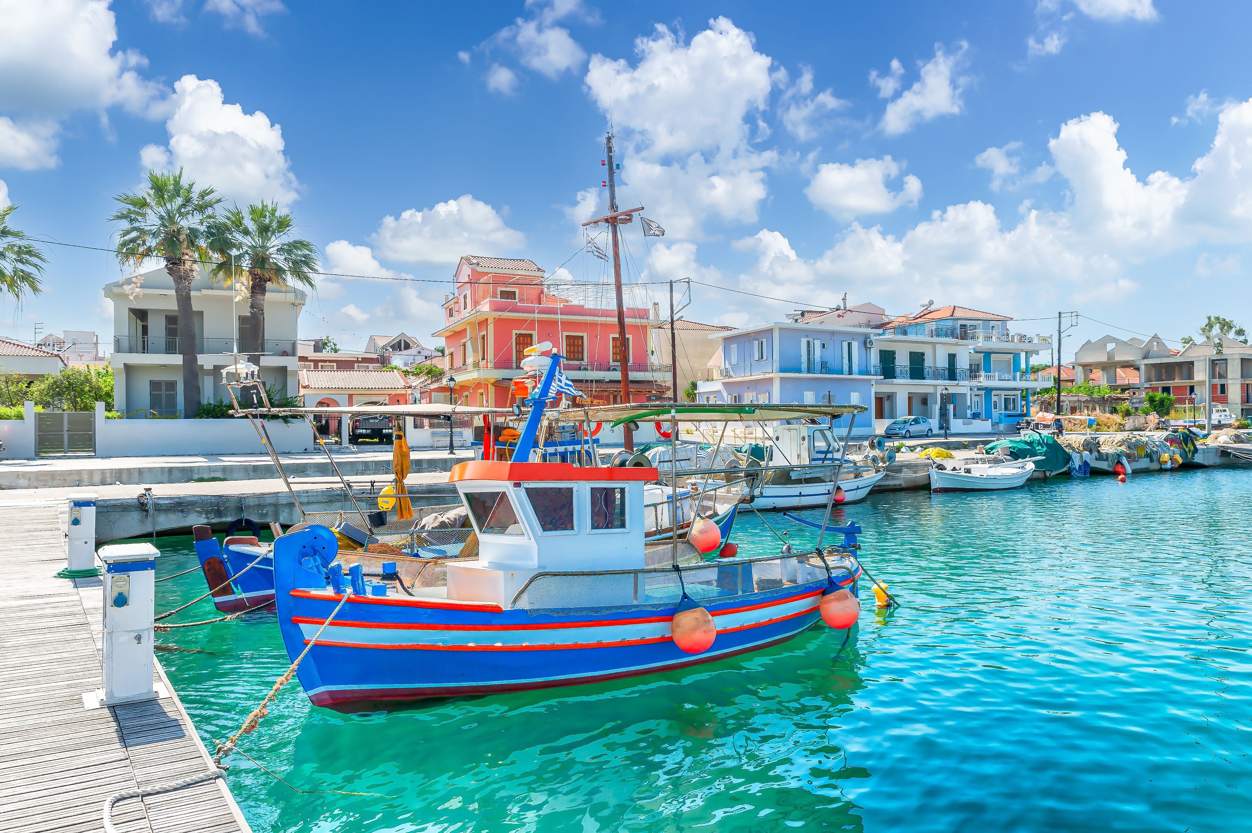 A view of colourful fishing boats moored at the harbour in the resort of Lixouri in Kefalonia