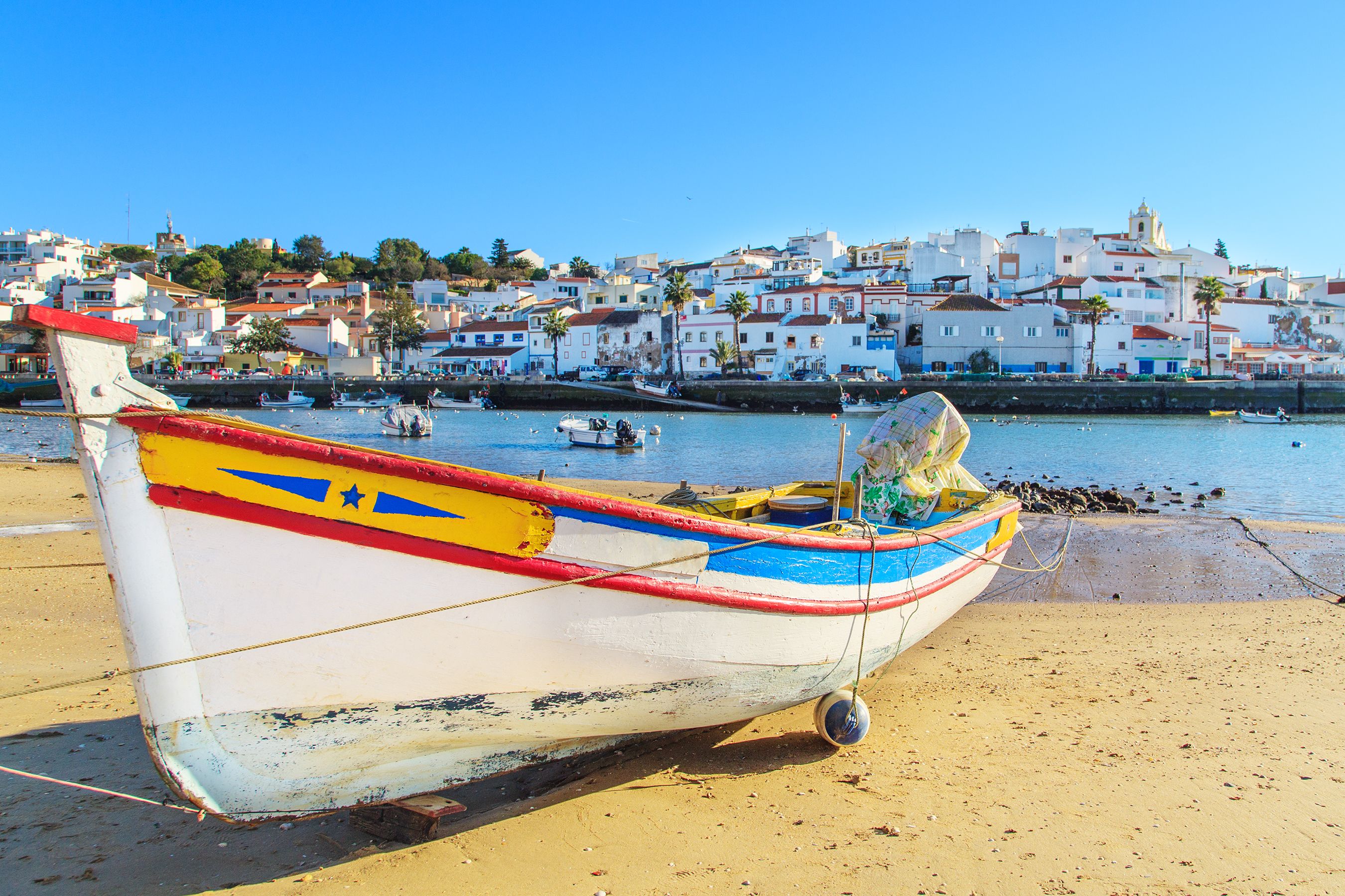 A traditional fishing boat on a beach in Portimao, the Algarve
