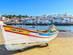 A traditional fishing boat on a beach in Portimao, the Algarve