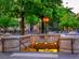 A view of the entrance to a metro station in Paris with green trees in the background
