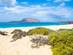 A view of Montaña Clara island across the sea from a sandy beach on La Graciosa, Canary Islands