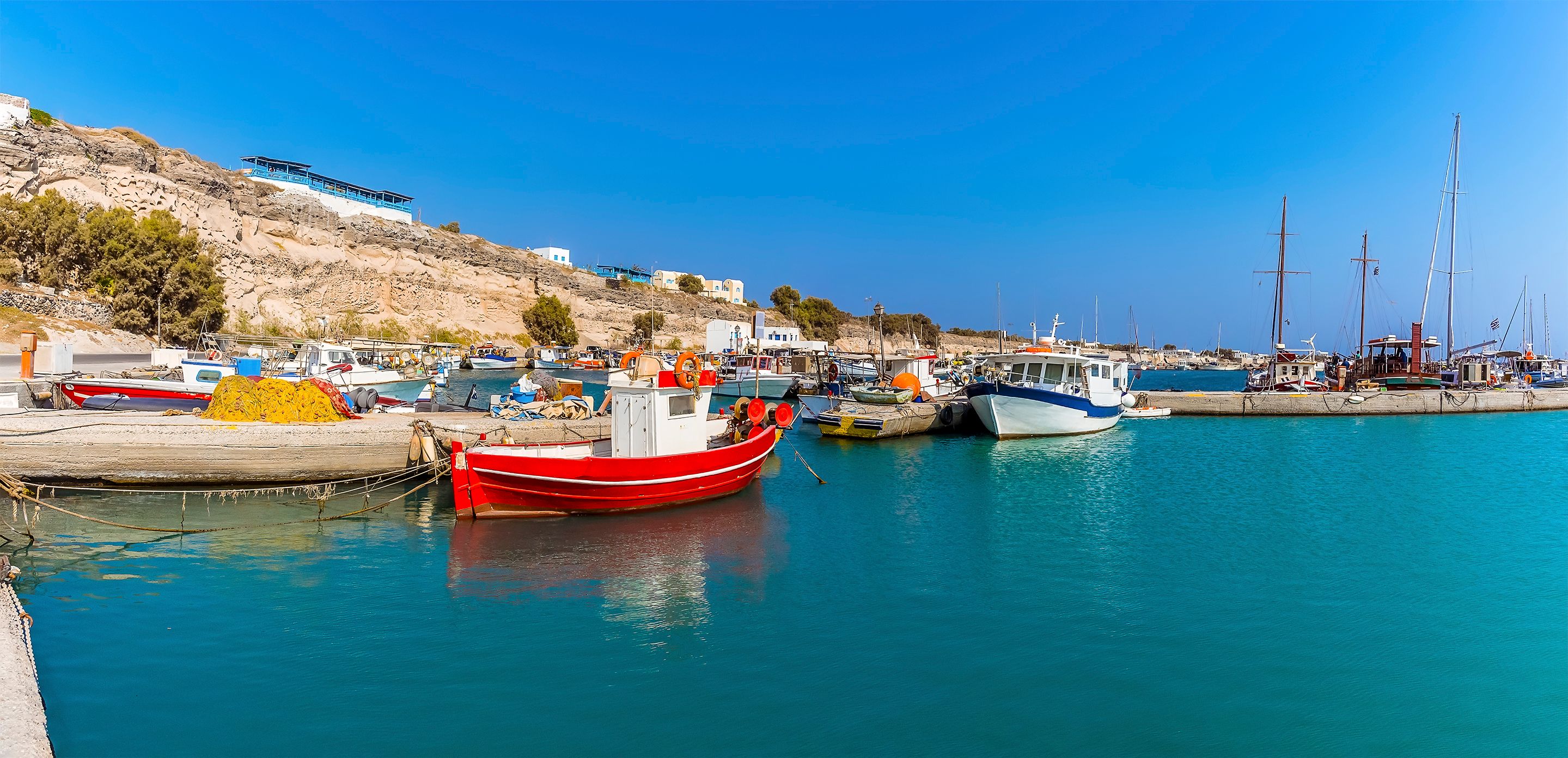 Colourful fishing boats in the harbour of Vlychada in Santorini