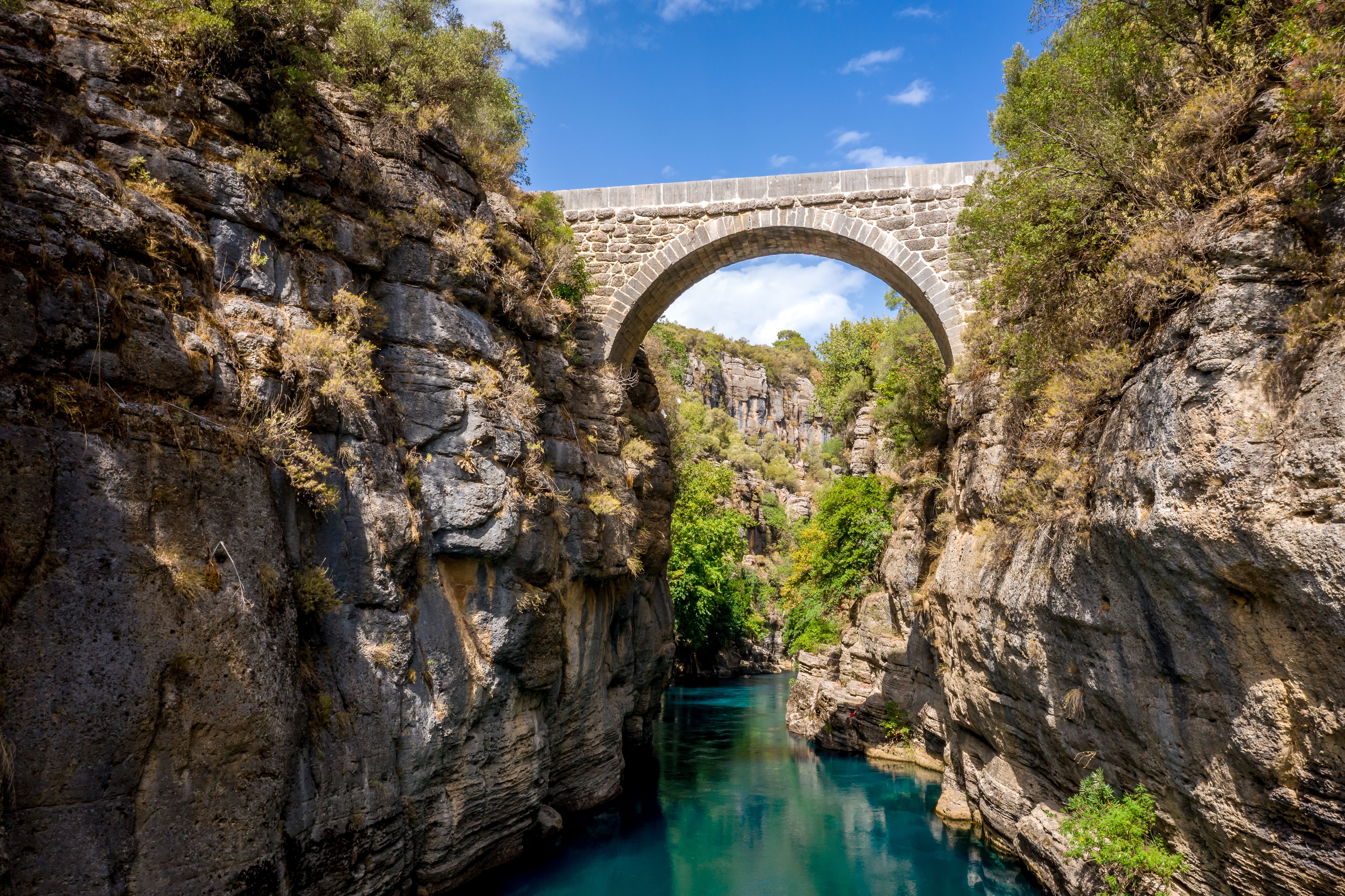 Ancient arch bridge Oluk over the Koprucay river gorge in Koprulu Canyon National Park in Turkey.