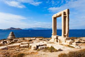 Serene image of Naxos Portara ruins, also known as Apollo Temple entrance gate, on the Palatia islet off Naxos island in Greece overlooking the sea