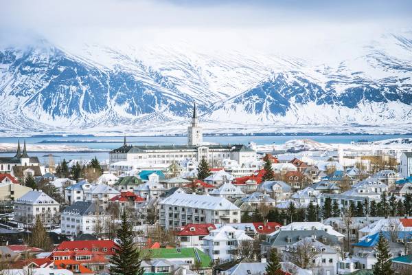 A picturesque view from above of Reykjavik the capital city of iceland in winter with snowy mountains on a clear day