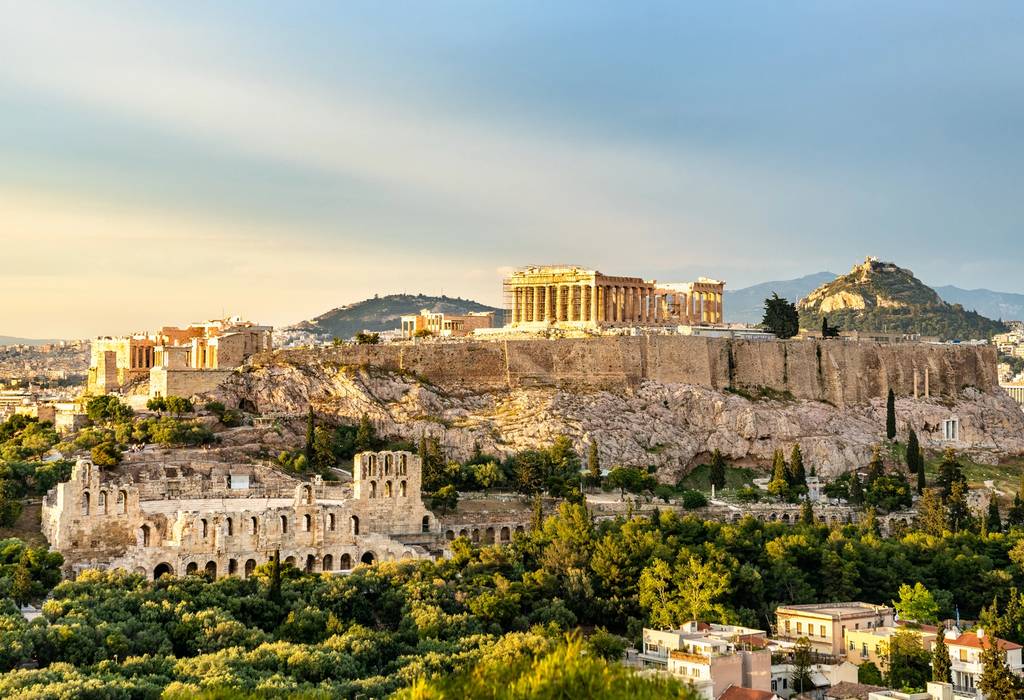 A sunset lights the Parthenon in on top of the Acropolis Hill in Athens