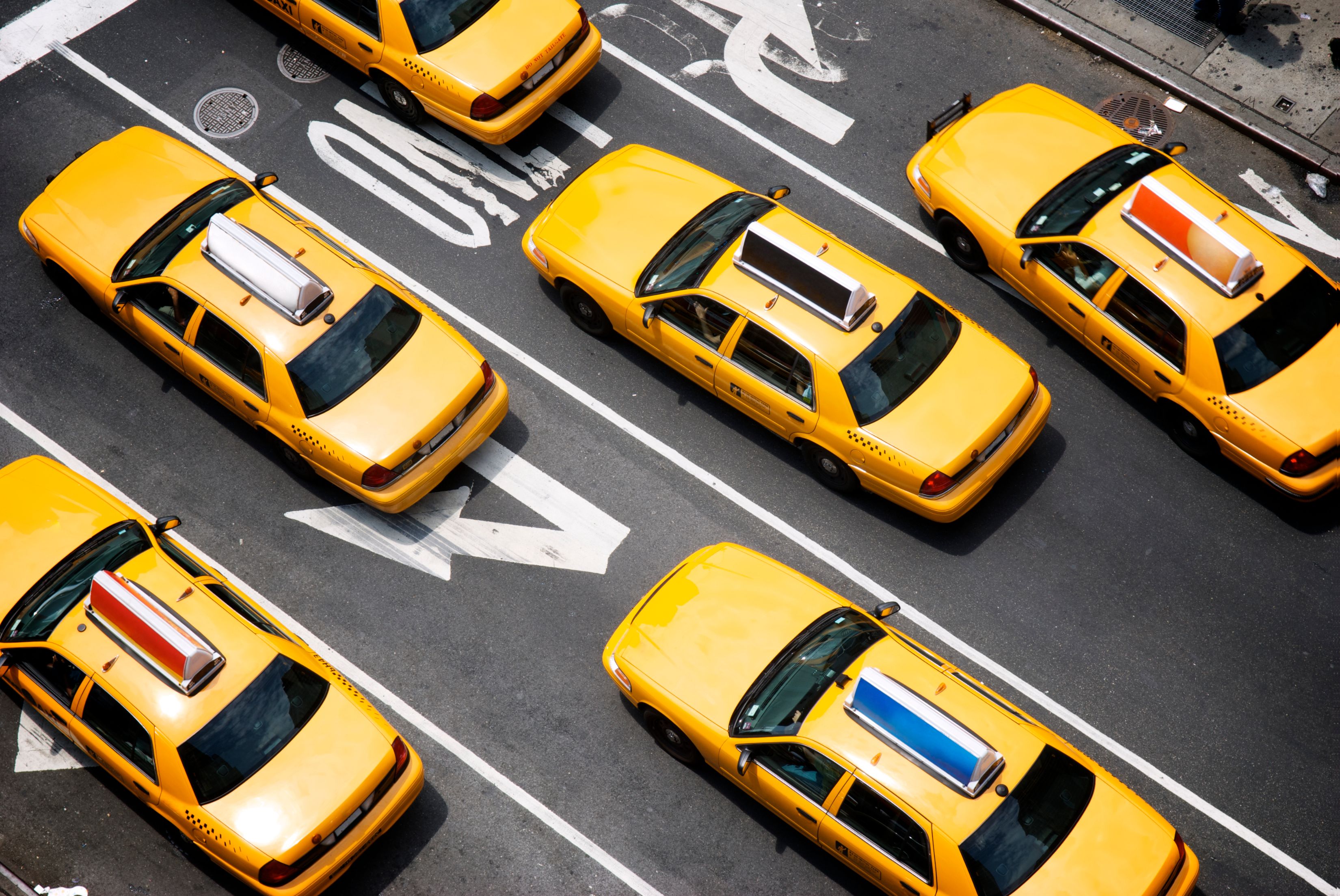 Bird's eye view of a fleet of yellow taxis on the streets of New York