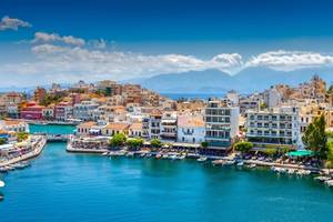 Picturesque town of Agios Nikolaos on a sunny day showing the harbour, town and sea on the island of Crete in Greece