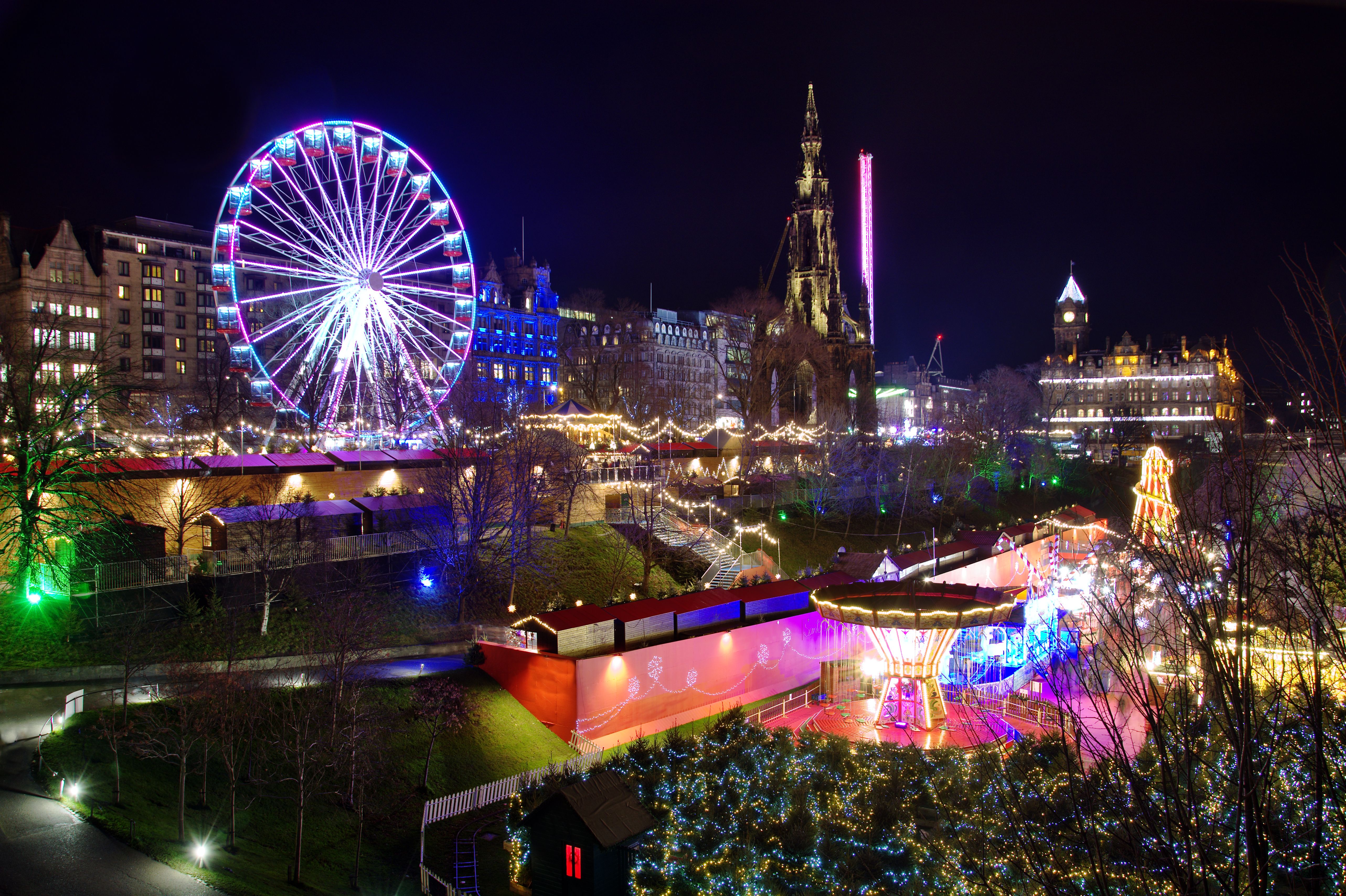 Christmas Market at Edinburgh, Scotland with lit up Big Wheel and festive lights