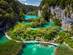 A view of a wooden walkway through the lakes and waterfalls of Plitvice Lakes National Park in Croatia