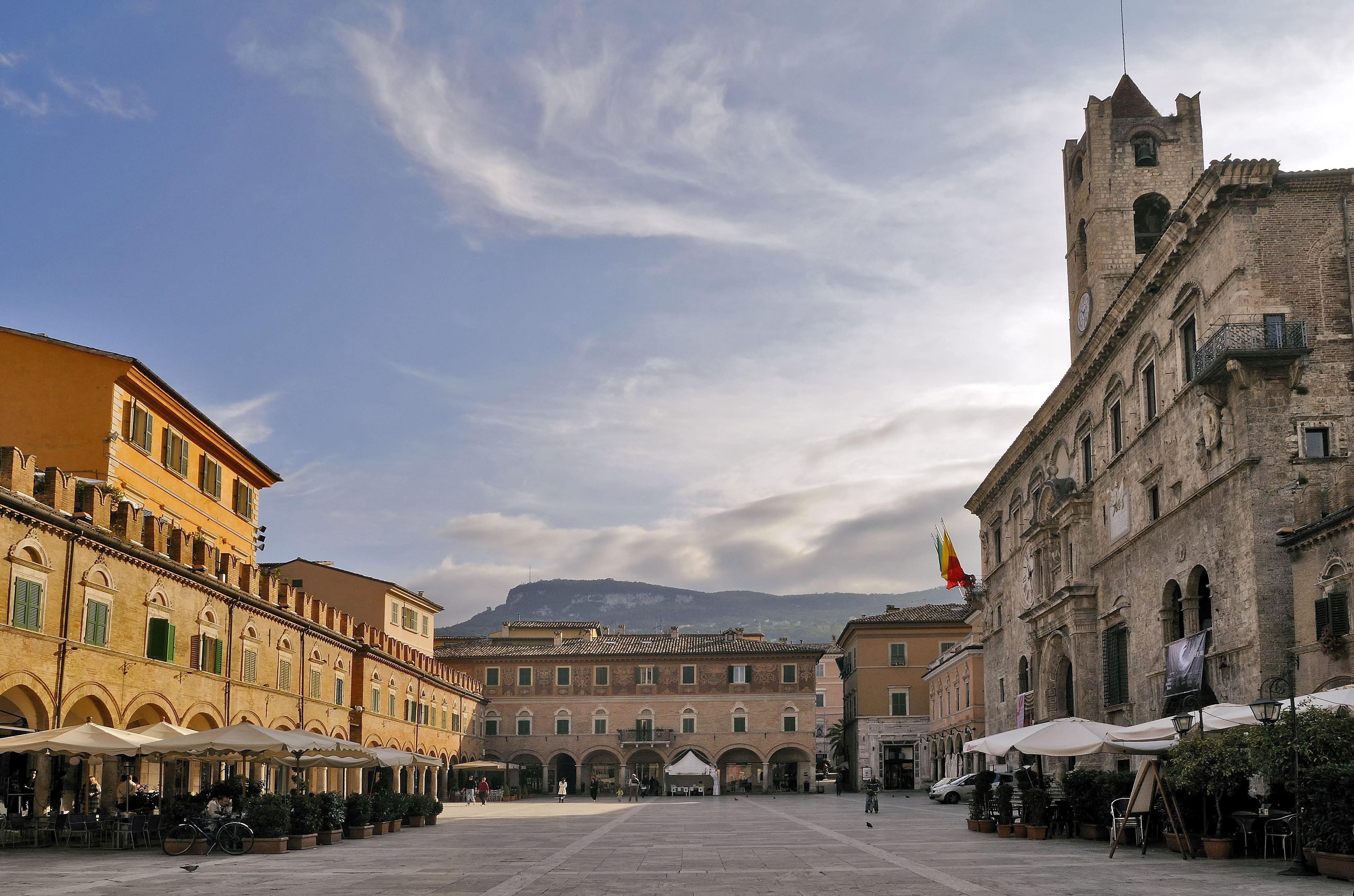 View of an empty cafe-lined piazza in Italy in the soft morning light