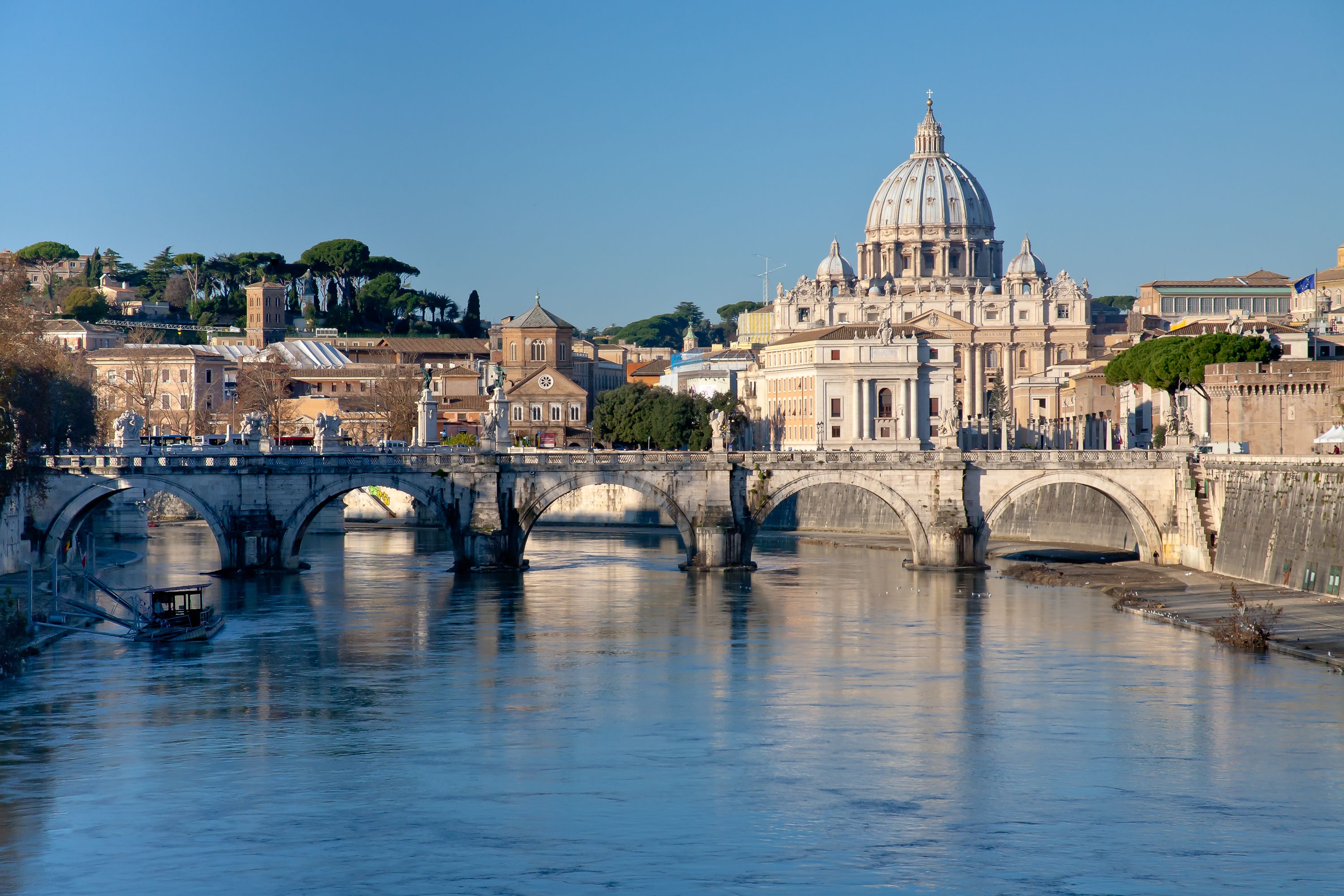 View of the Tiber River and St Peter Basilica in Rome on a crisp, winter's day