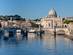 View of the Tiber River and St Peter Basilica in Rome on a crisp, winter's day