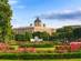 View across the lush, rose-filled gardens of Vienna's Volksgarten Park with the golden Kunsthistorisches Museum and it's domed roof in the background