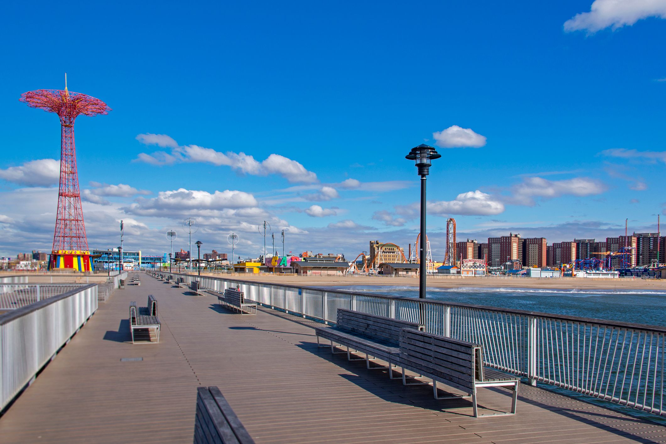Pier and view over the beach and amusement park at Coney Island, New York.