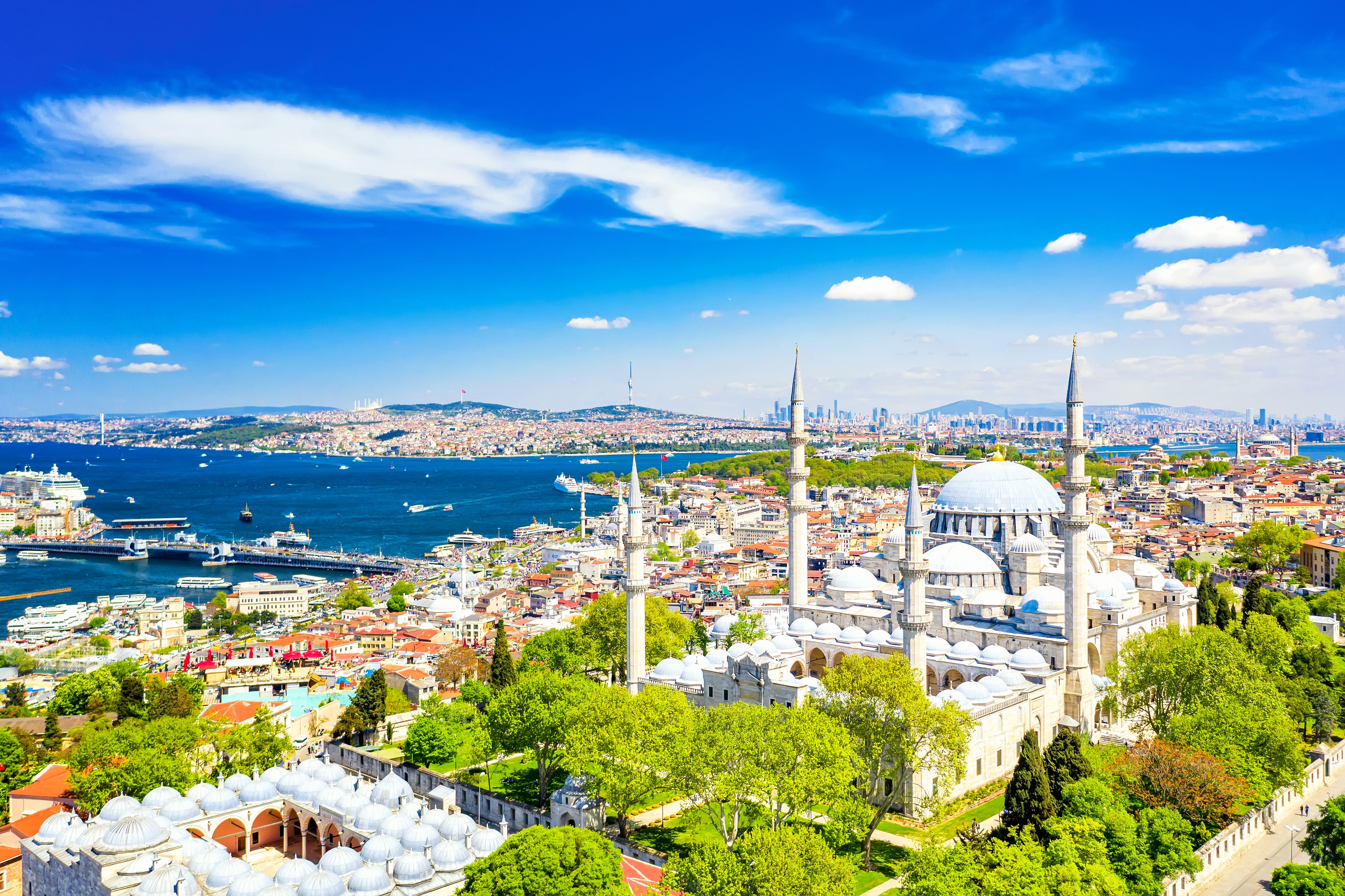 Aerial view of the Suleymaniye Mosque, with its domed roof and spiky minarets, and Istanbul's Golden Horn waterway in the background