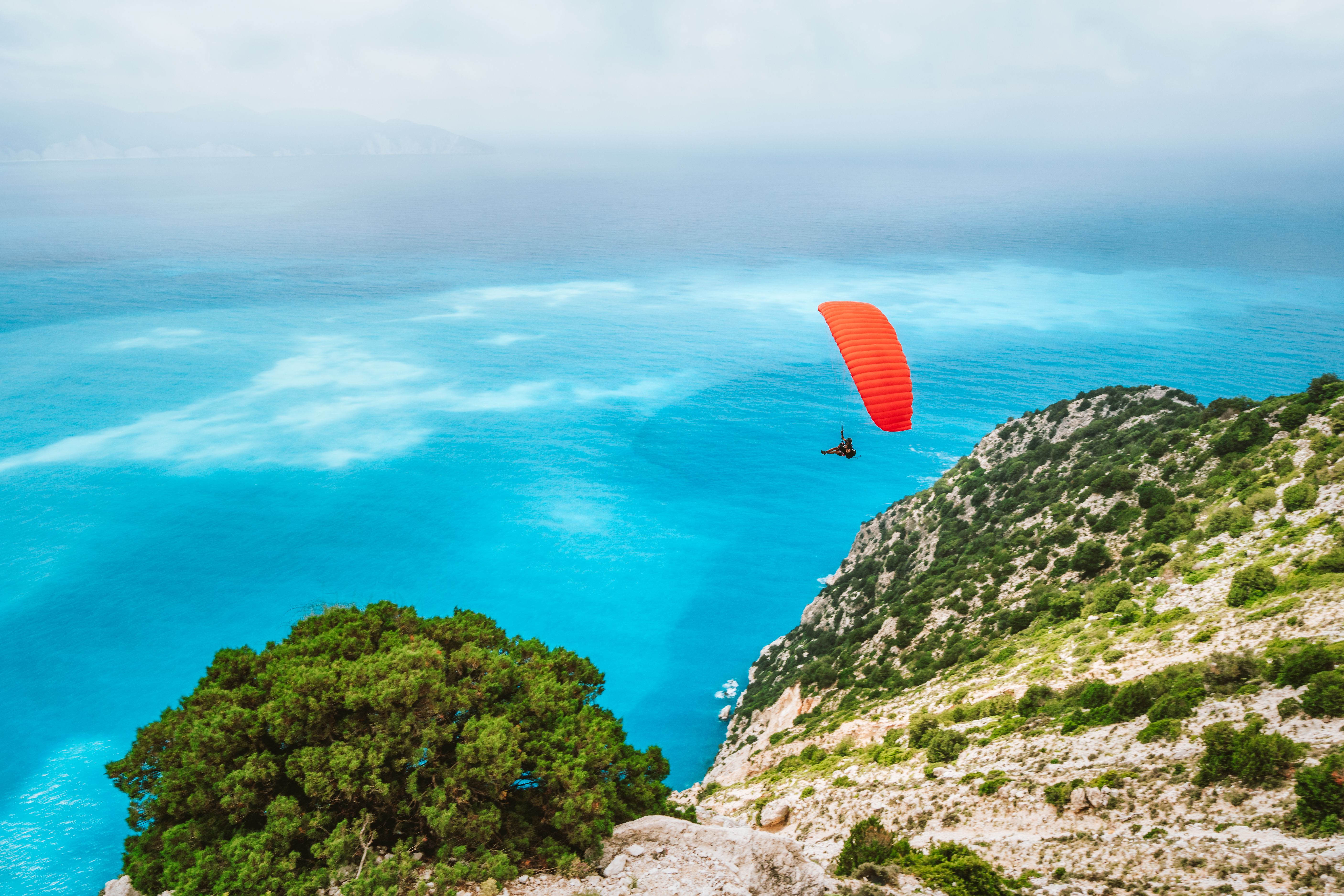 Paraglider flying at Myrtos beach, Kefalonia