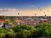 Panorama of Vilnius old town with colourful hot air balloons in the sky