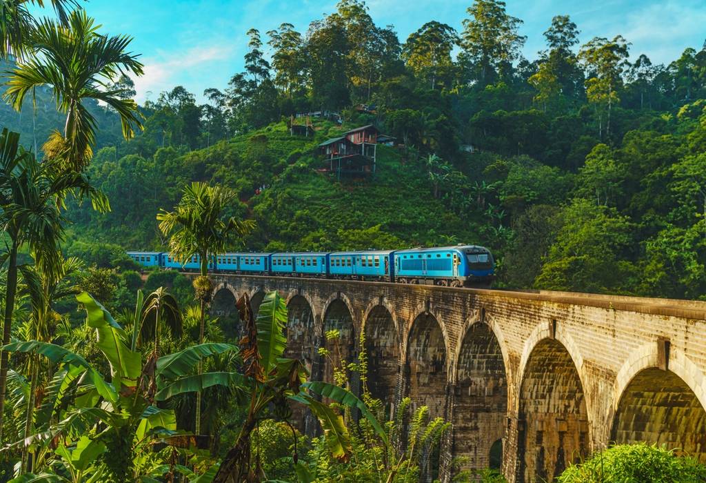 View of an iconic train travelling over the Nine Arch Bridge in Demodara, Ella, Sri Lanka