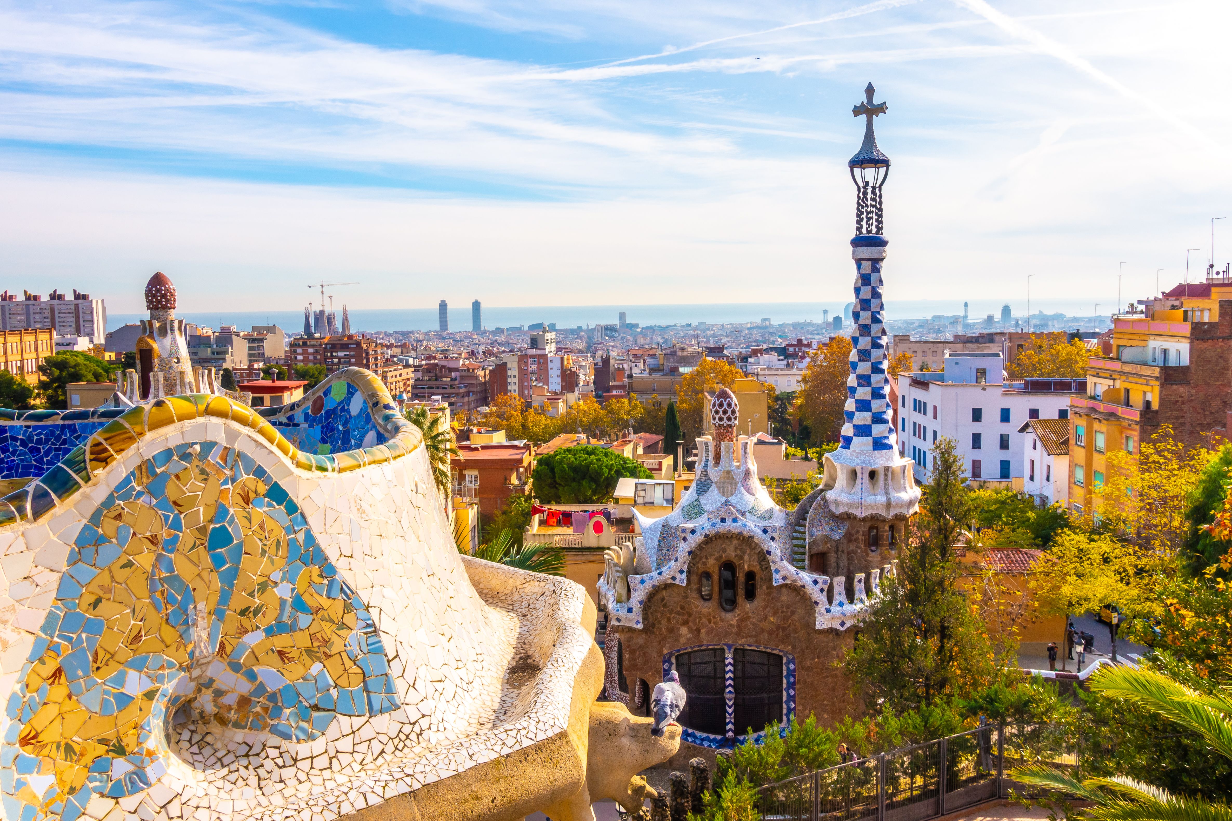 A panoramic view of Park Guell in Barcelona with mosaic covered buildings