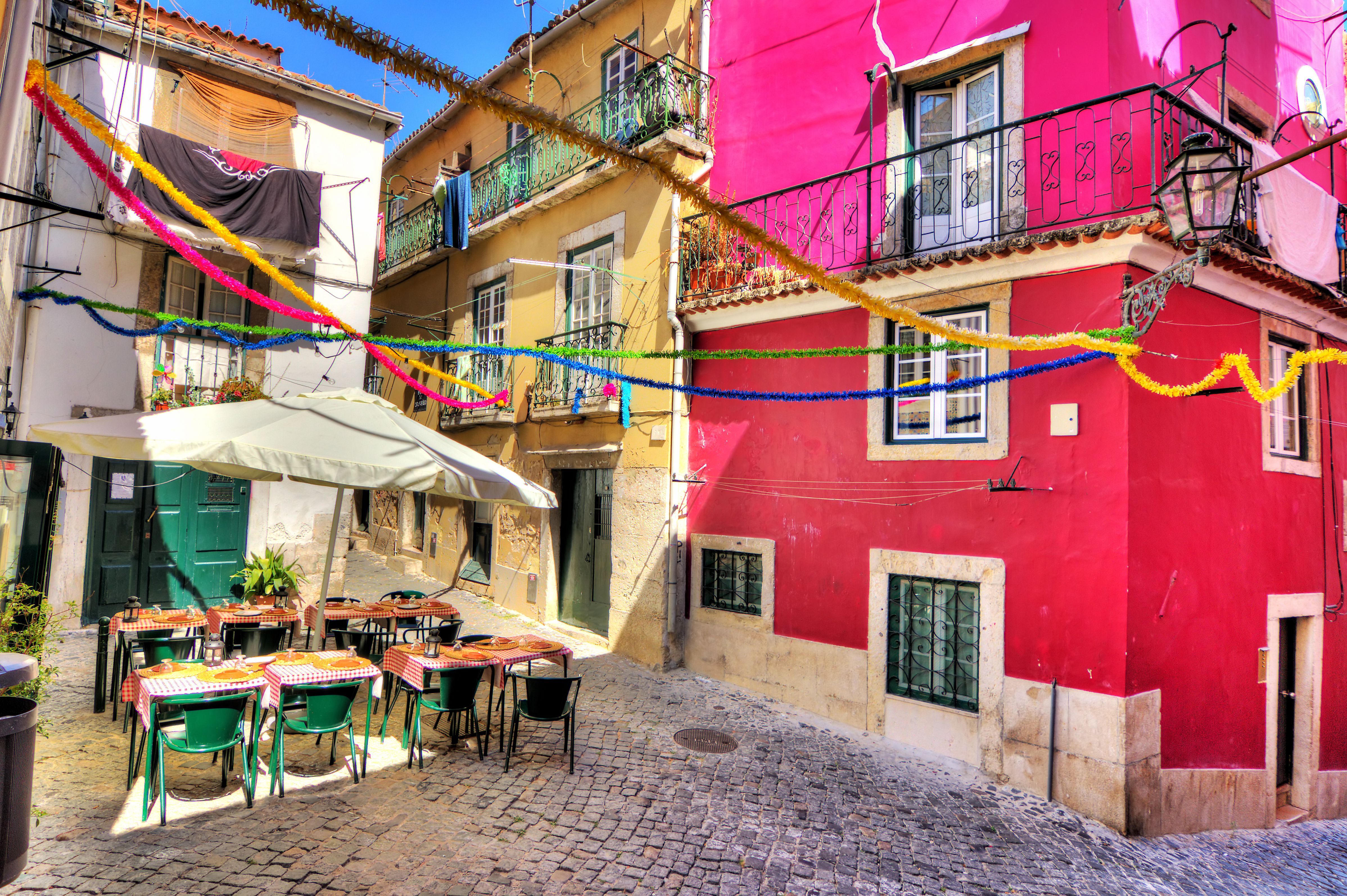View of colourful cafe tables and buildings in a side street in Bairro Alto, Lisbon