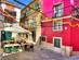 View of colourful cafe tables and buildings in a side street in Bairro Alto, Lisbon
