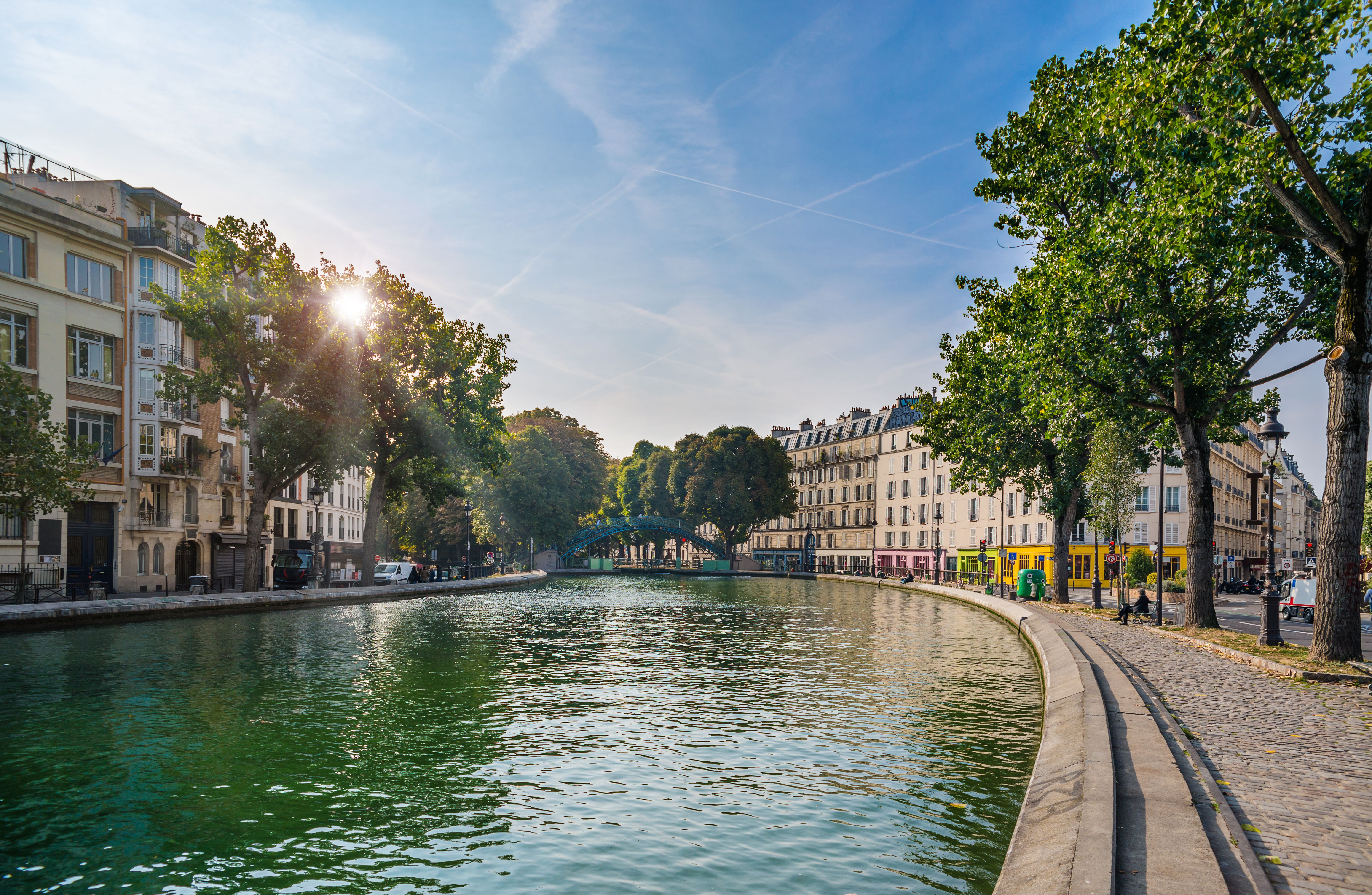 A view of Canal Saint Martin in Paris on a bright blue day