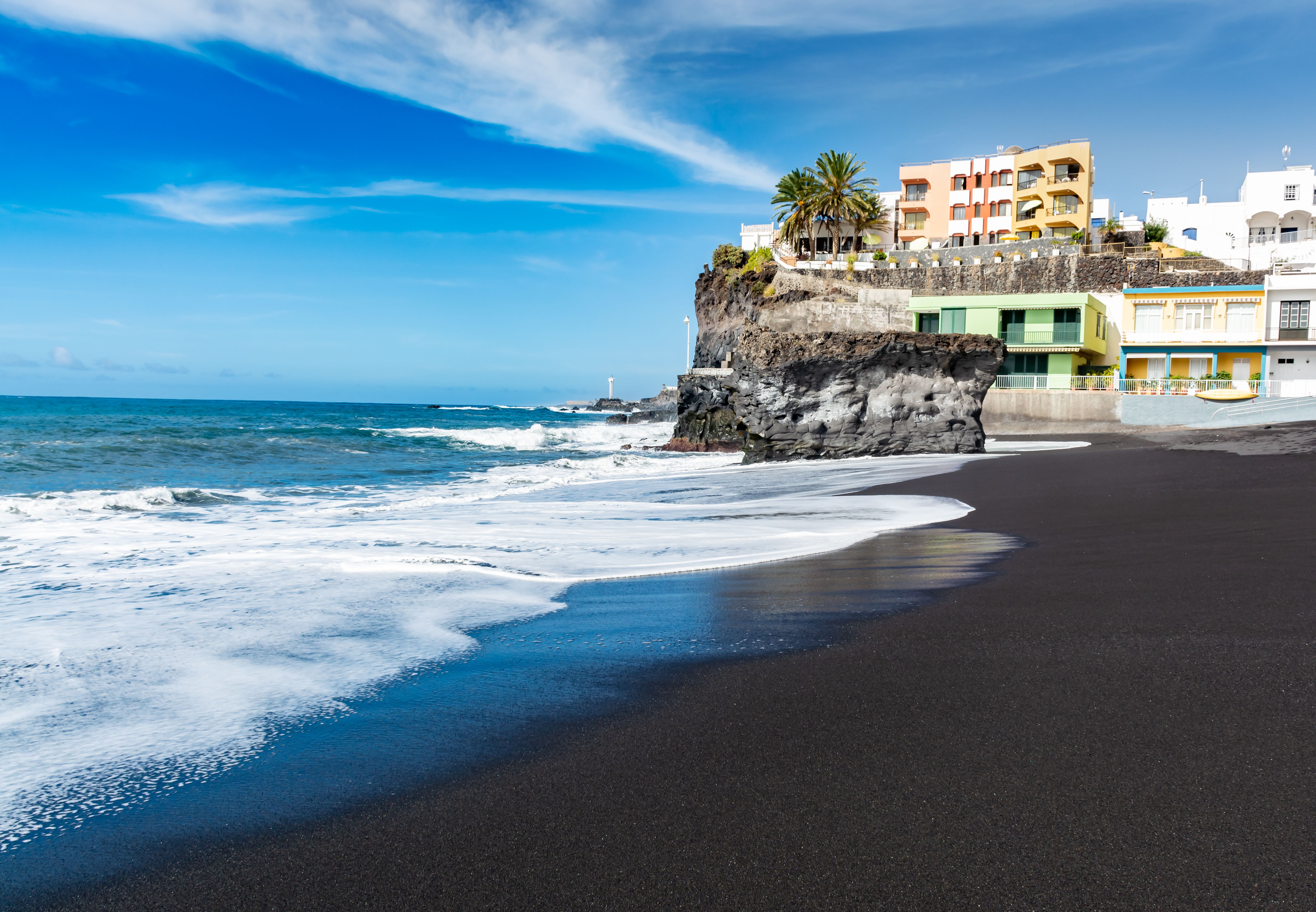 A view across the black sand beach of Puerto Naos resort in La Palma, Canary Islands
