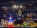 A view of Funchal city lit up at Christmastime in Madeira with an LED-lit Christmas tree