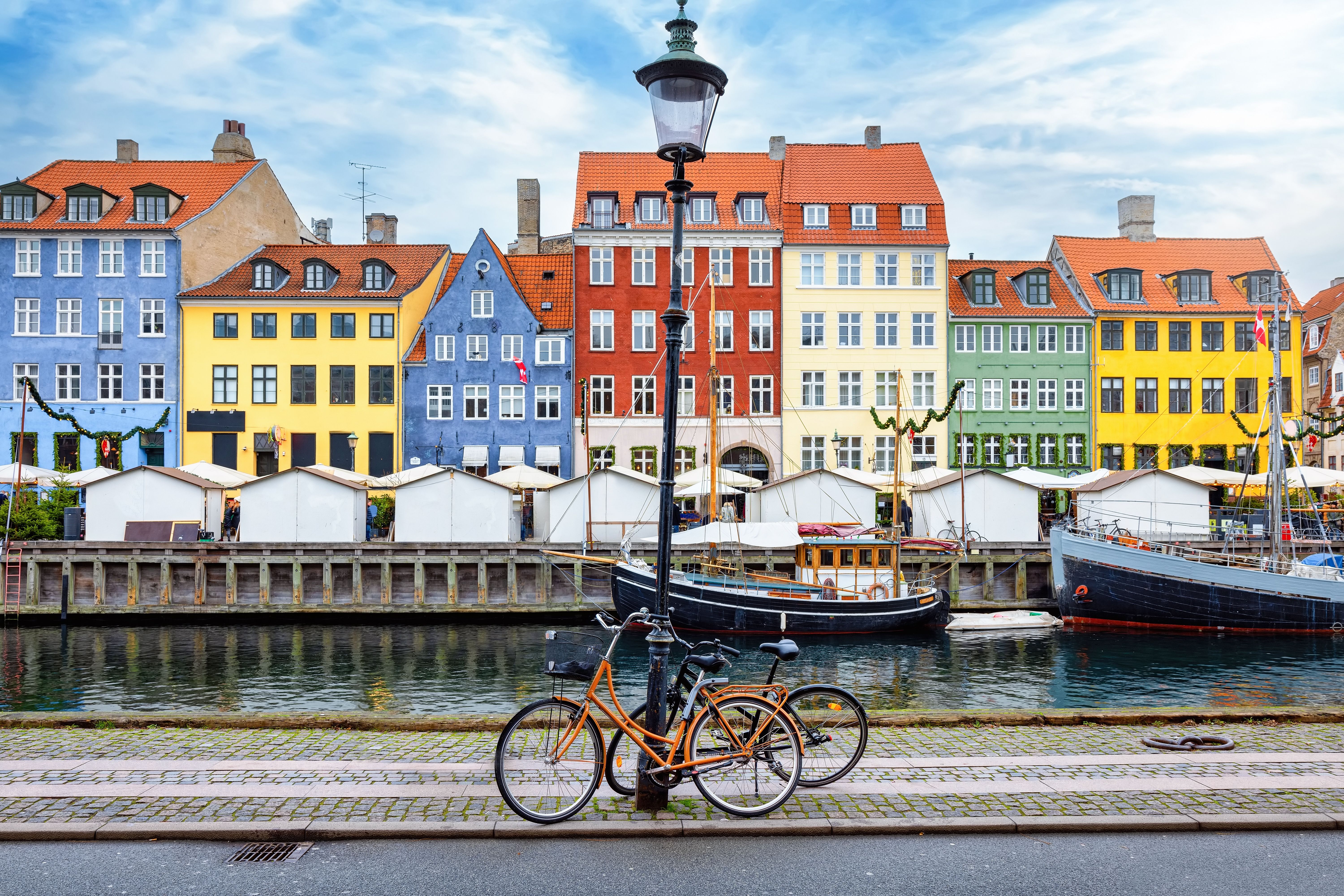Nyhavn harbour in Copenhagen, Denmark on a bright, winter day with a street light and bicycles in front of the colourful houses