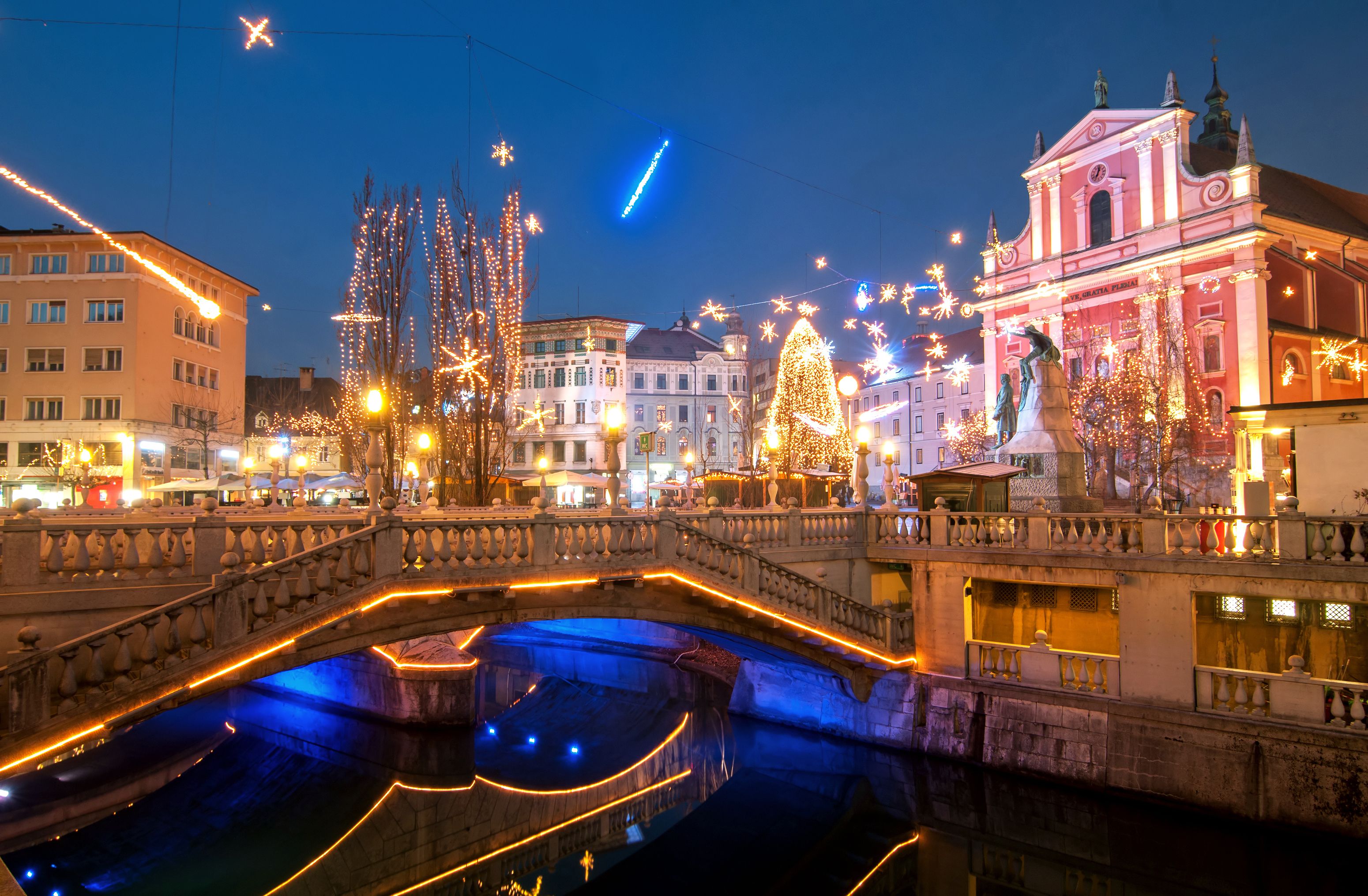 A view of Triple bridge and Ljubljana city centre decorated for Christmas with multi-coloured lights