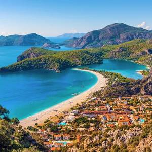 An aerial view of Oludeniz beach and lagoon in Turkey on a clear blue day showing the beach, sea, sand and village