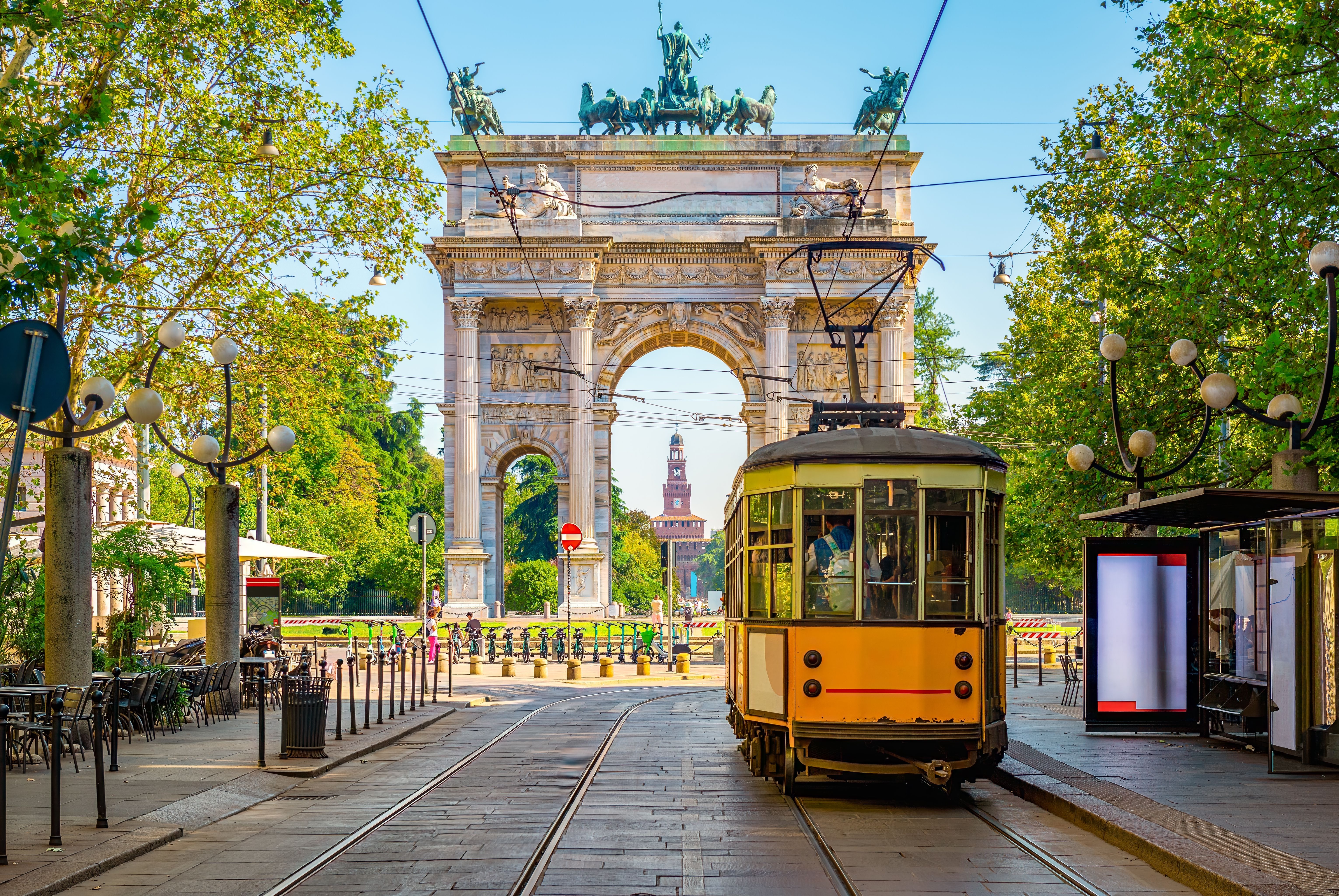 View of the Peace Arch with yellow tram in Milan, Italy