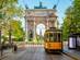 View of the Peace Arch with yellow tram in Milan, Italy