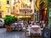 Outdoor tables and chairs at a courtyard restaurant in Rome, Italy