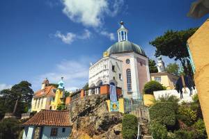 Low angle view of the pastel pink and yellow Italian-style buildings of purpose-built tourist village, Portmeirion