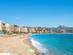 View of the golden sands and turquoise waters of Malagueta city beach in Malaga