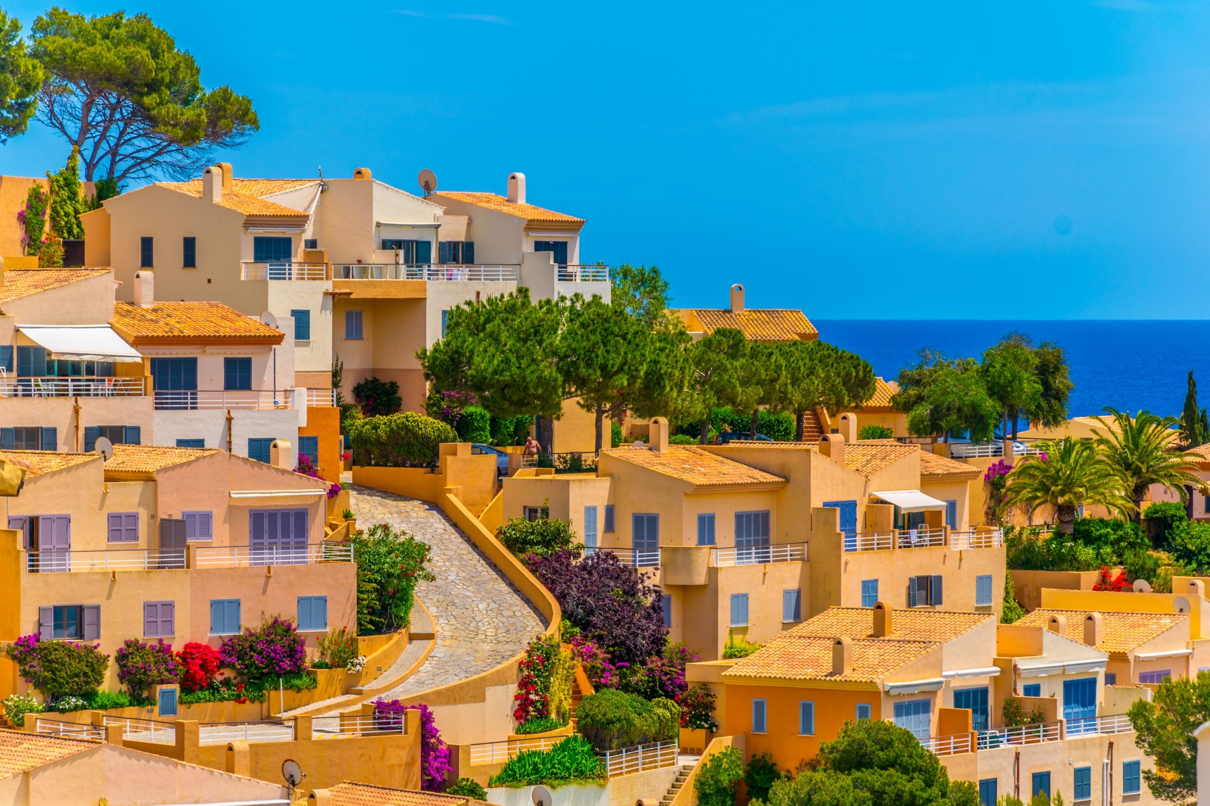 Orange houses on a hillside in Canyamel town in Majorca