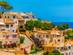 Orange houses on a hillside in Canyamel town in Majorca