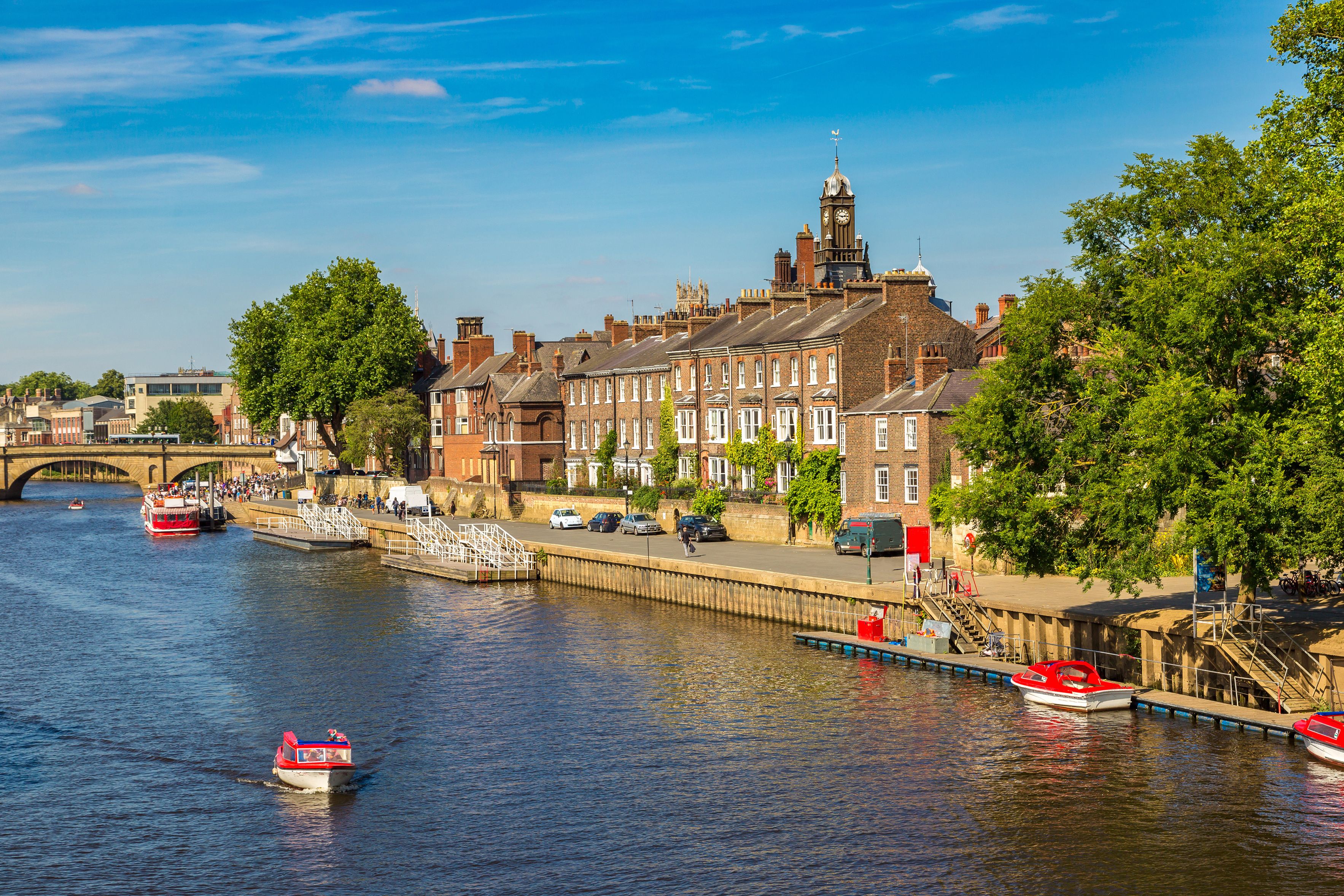View across a river lines with typical English-style architecture in York.