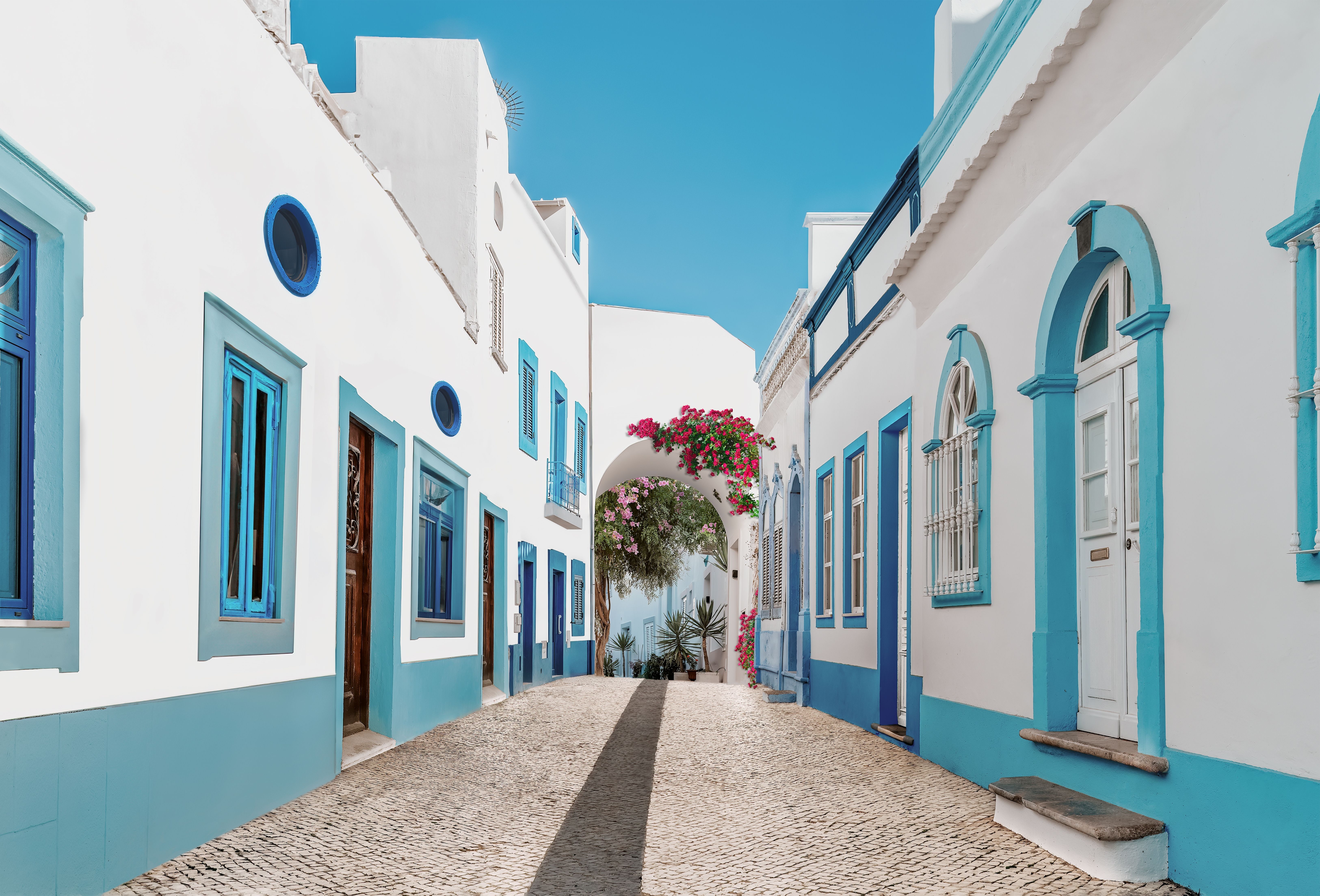 Blue and white houses on a street in Olhao, Algarve