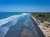 Aerial view of a palm-fringed beach in the Gambia.