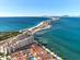 Aerial view of high rise apartments and a huge hotel-lined sandbar in Spain.