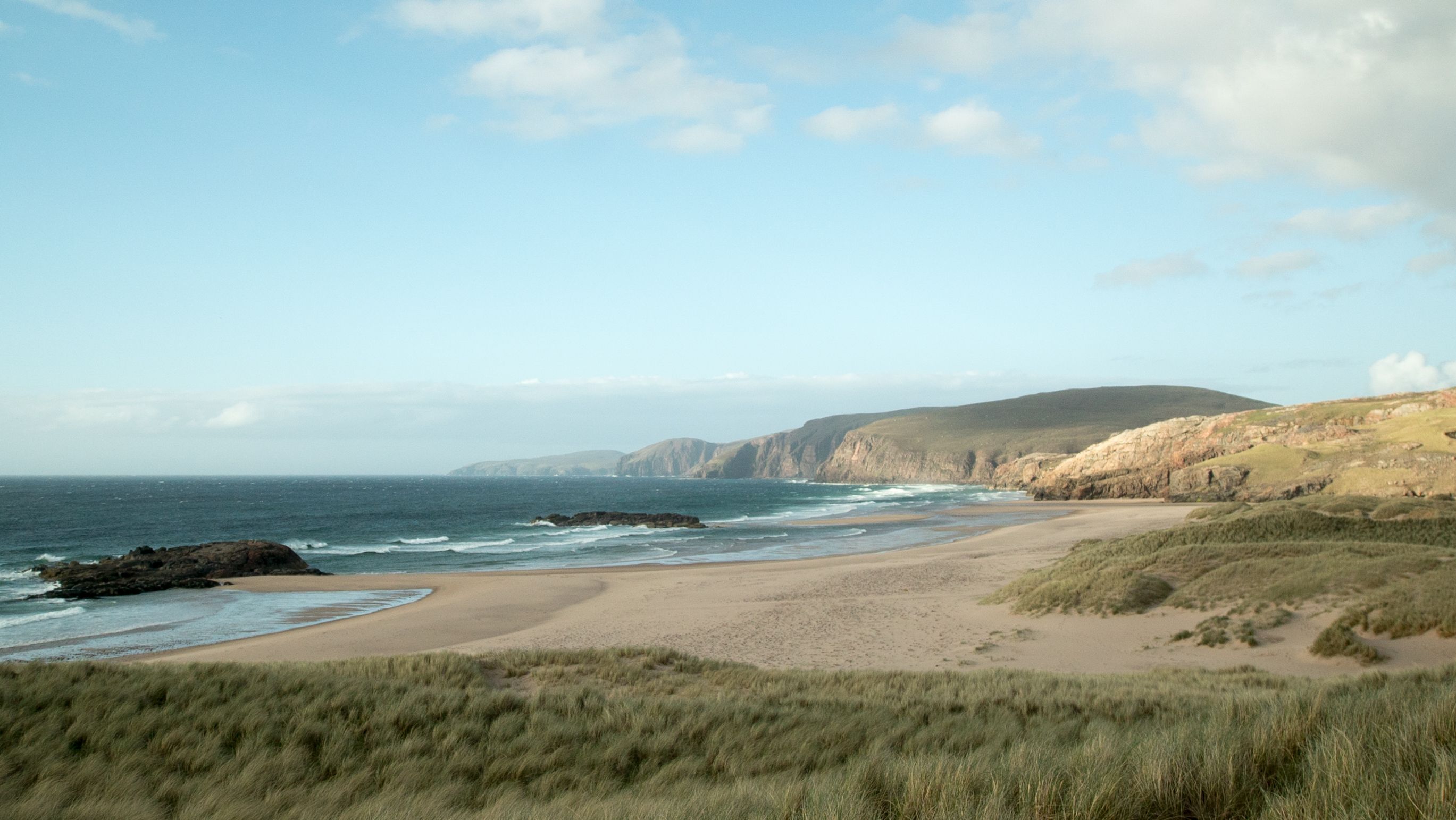 Dusky view of an empty, sandy beach in Scotland