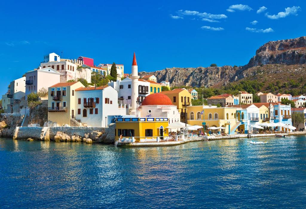 A view of colourful houses on the waterfront of Kastellorizo island in Greece on a bright, sunny day