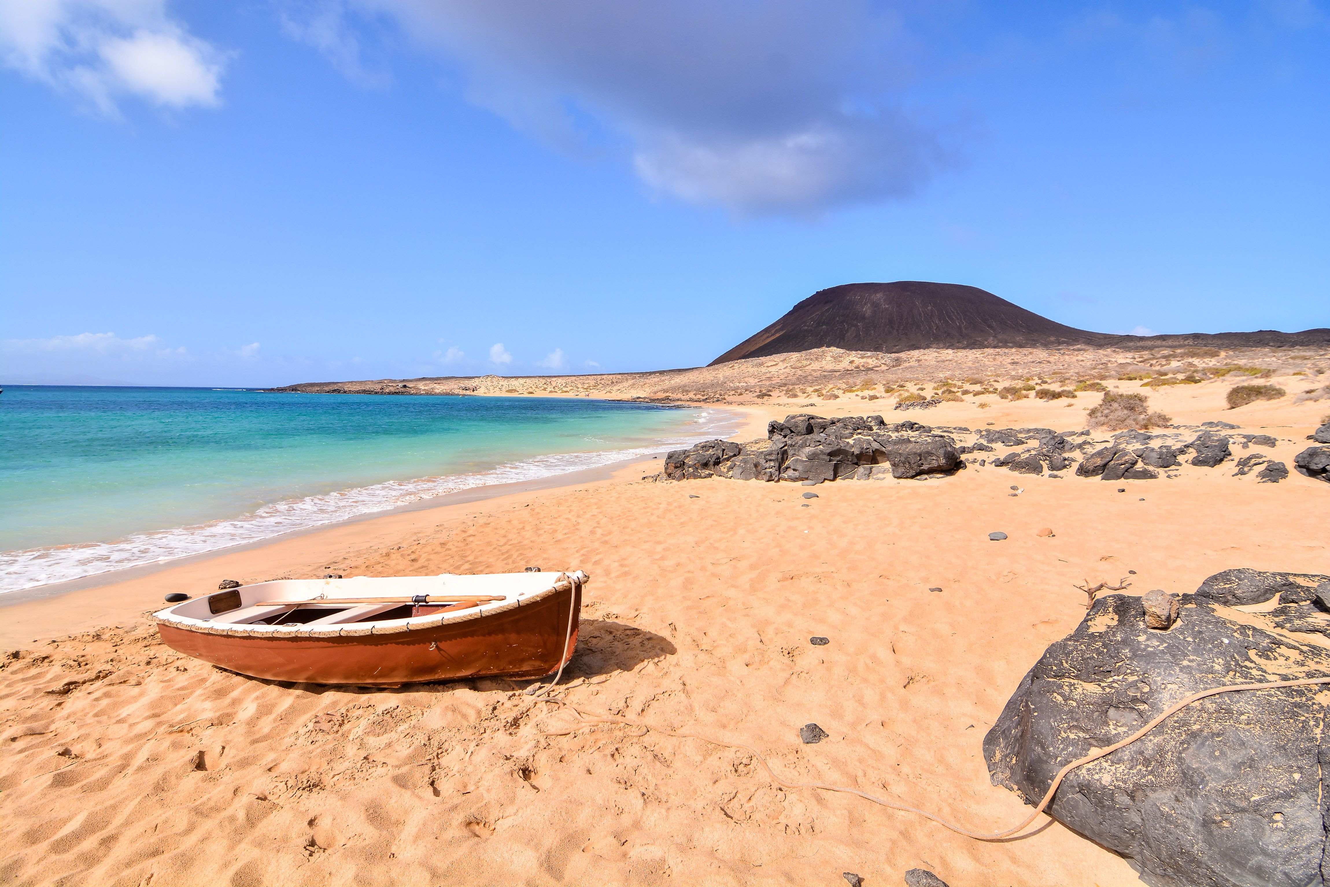 A rowing boat on an empty beach on the island of La Graciosa in the Canary Islands